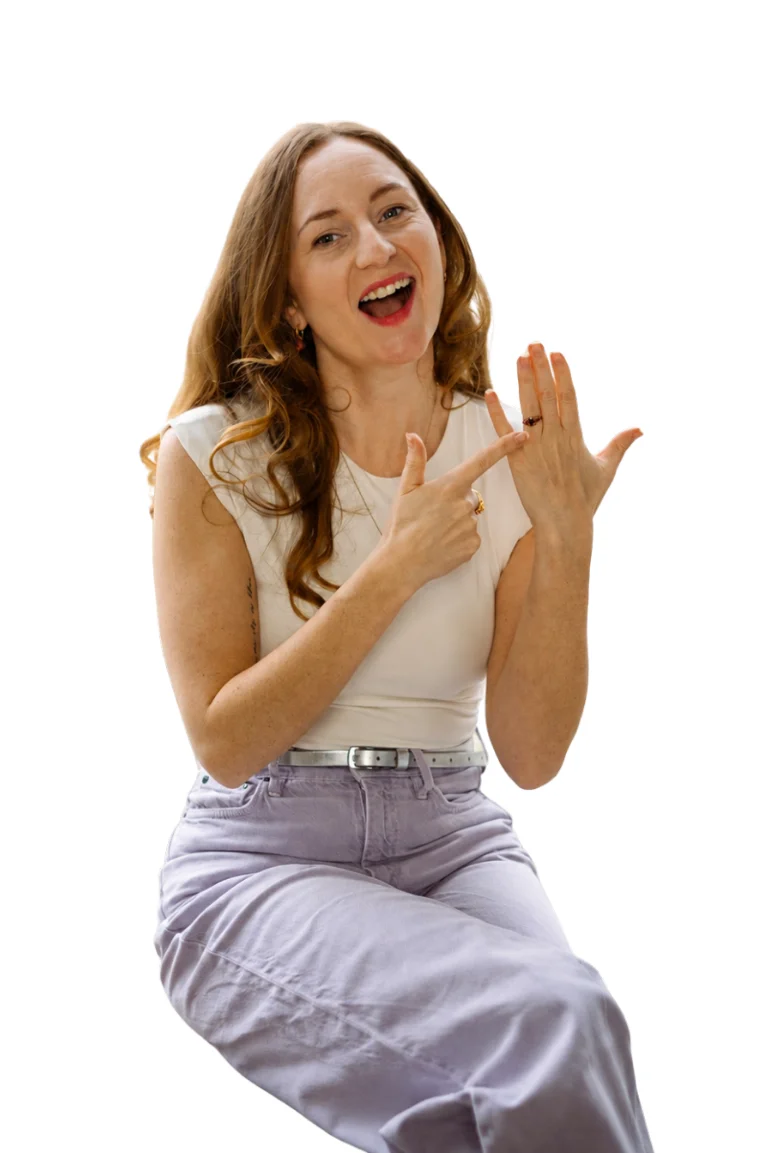 Lucinda, founder of Wifey Web Studio, pointing to the ring on her finger